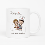 Load image into Gallery viewer, Front view: Love is... the secret ingredient personalized ceramic mug by Kim Casali.
